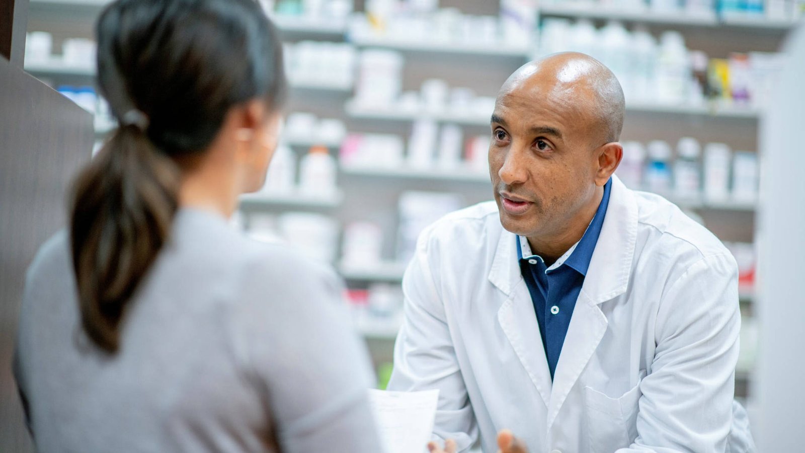 Veritas Pharma pharmacist assisting a customer